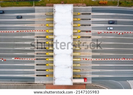 View from a height of the checkpoint. Cars pass through an automatic toll booth on a toll road in Europe. Poland