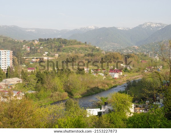 View from a height of\
the city and mountains. Suburb of a southern city and mountains in\
the background.\
