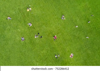 View from the height of the people are resting on the lawn in the park