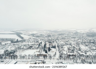 View From A Height Of A Small Village In Winter. Snowy Village, Snow-covered Houses And Roads. February Weather In Ukraine