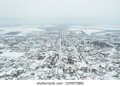 View From A Height Of A Small Village In Winter. Snowy Village, Snow-covered Houses And Roads. February Weather In Ukraine