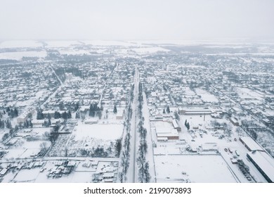 View From A Height Of A Small Village In Winter. Snowy Village, Snow-covered Houses And Roads. February Weather In Ukraine