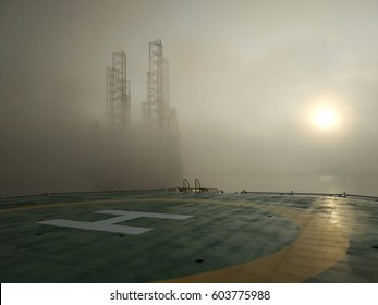 View of helicopter deck or helipad with thick morning fog during sunrise and noise background. 