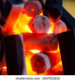 A view of hexagonal charcoal briquettes on the fire being burnt