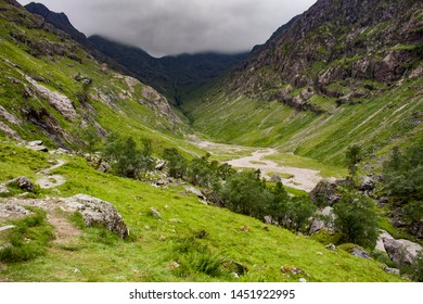 View of the Hidden-valley in the Scottish Highlands. This place is approachable from the Glencoe-valley and it is a famous tourist attraction. Rocky mountains, green wide valley on the picture. - Shutterstock ID 1451922995