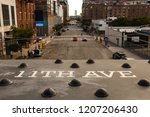 View from The High Line in New York City on the 11th Avenue with railing in the foreground and avenue in the blurred background