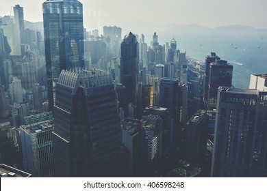 View From High On A Business Center With High Skyscrapers And Sea With Floating Yachts. Modern Developed Metropolitan City With Office And Commercial Buildings With Contemporary Architecture 