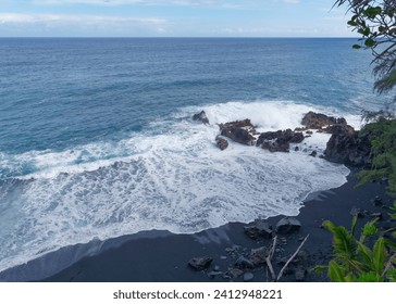 View from the hill at beautiful Kehena black sand beach located in the Big Island's Puna district, Hawaii - Powered by Shutterstock