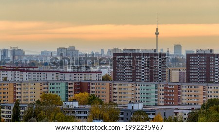 view from hill over the roofs of east-berlin during sunset with television tower in the background