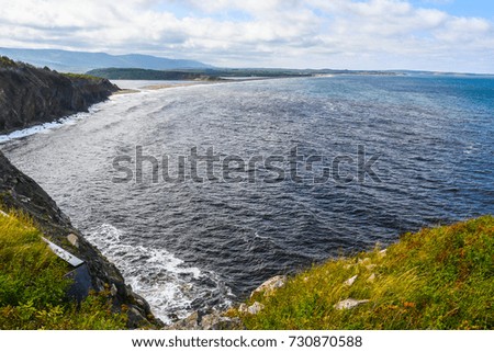 A view of hills and mountains and the Atlantic ocean from the Cabot Trail in Nova Scotia, Canada