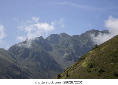 view of hilly, mountainous terrain with clouds