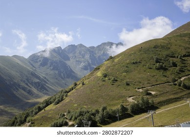 view of hilly, mountainous terrain with clouds