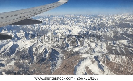view of the himalayas from the plane window