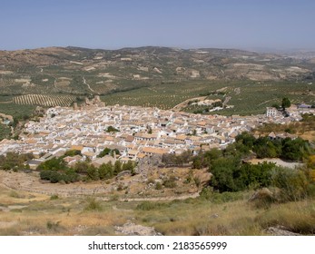 view of the historic center and the castle of the town of Zuheros in Córdoba and in the background a huge countryside of olive trees