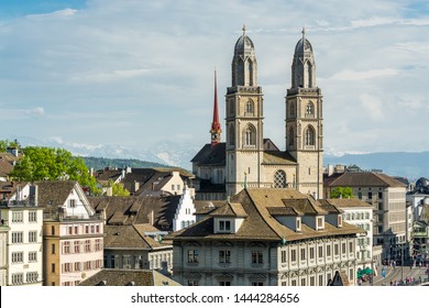 View of the historic center of Zurich at the bank of Limmat River, with beautiful house rooftops and church Grossmunster , view form Lindenhof hill.