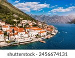 View of the historic town of Perast at famous Bay of Kotor on a beautiful sunny day with blue sky and clouds in summer, Montenegro. Historic city of Perast at Bay of Kotor in summer, Montenegro.