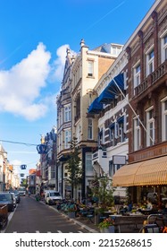 View Of Historical District Of Old Town The Hague Overlooking Narrow Picturesque Street With Old Buildings, Shops And Open Air Restaurants On Sunny Summer Day, Netherlands.