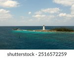 A view of the Hog Island Lighhouse in Nassau Bahamas with stormy seas surrounding it