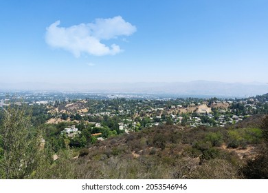 View Of Hollywood Hills Seen From Mulholland Drive On A Sunny Summer Day. Houses, Trees And Dry Patches Of Land Stretching Across The Valley