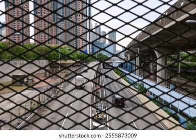 The view of Hong Kong cityscape, Looking from chain link fence. Street scene, modern city. Hong Kong city. Travel and city concept. - Powered by Shutterstock