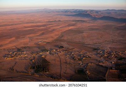 The View From A Hot Air Balloon Down To The Desert Village Near Marrakech, Sunrise In April, Morocco