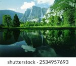 view of huge snowy mountains
mountains and forest are visible from under the water
clouds are passing over the mountains
it is a lake
beautiful view of lake water
very cute lake picture