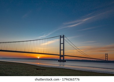 A view of the Humber Bridge from the south bank of the River Humber during sunset.