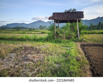 View of a hut on plantation against hilss and bright sky,location in Wonogiri,Indonesia.