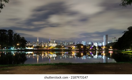 View of Ibirapuera Park, the first metropolitan park in São Paulo, Brazil, and one of the most visited parks in South America. In the background part of the city’s skyline reflected in a lagoon