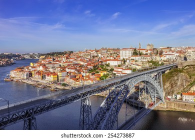 View of the iconic Dom Luis I bridge crossing the Douro River, and the historical Ribeira and Se District in the city of Porto, Portugal. Unesco World Heritage Site.