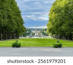 A view of the iconic Vigeland Park in Oslo from the entrance, showcasing its famous sculptures, lush greenery, and beautiful pathways, blending art and nature seamlessly.