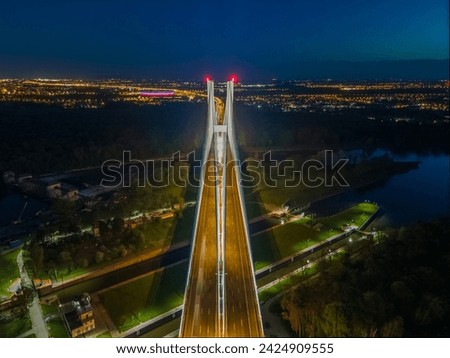 view of the illuminated bridge at night from a drone