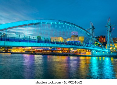 View of an illuminated footbridge in Salford quays during night in Manchester, England