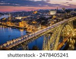 View of illuminated Porto city and Douro river and Dom Luis bridge I from famous tourist viewpoint Miradouro da Serra do Pilar in evening twilight. Porto, Vila Nova de Gaia, Portugal