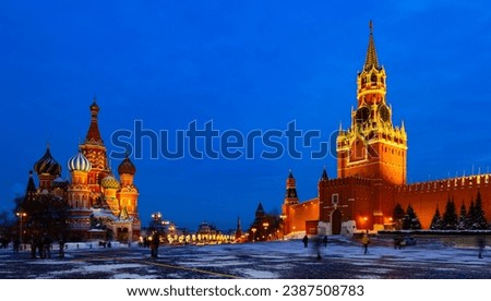 View of illuminated Spasskaya Tower and Saint Basils Cathedral on Red Square in Moscow on winter evening, Russia