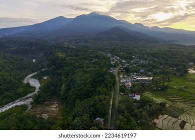 View of Indonesia in the morning, mountain village area and river and bright sun from aerial photography