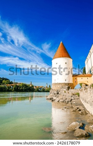 View of the Inn River and the Schaiblingsturm in Passau. Historic round tower of the city with the surrounding landscape. Old defense tower.	