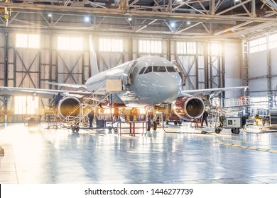 View Inside The Aviation Hangar, The Airplane Mechanic Working Around The Service