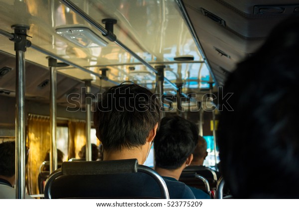 View from inside the\
bus with passengers