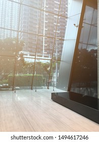 View From Inside The Business Building, Look Through The Glass With Large Joints Going Out To The Office Building Outside, Rain Is Coming. The Sky Is Not Very Clear, Artificial Light From Window.  