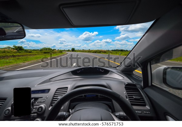 View from inside the car and\
drive a car on road with blue sky background, Selective\
focus