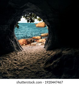 View from inside of cave on beach with turquoise color sea and big stones. Fantasy place.