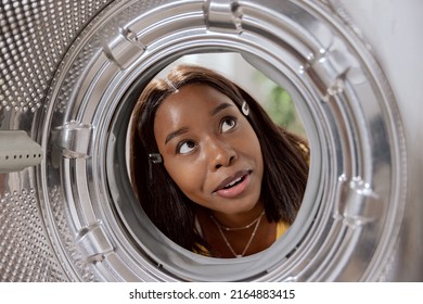 View From Inside The Drum, A Woman Has Bought A New Washing Machine Looks At It Carefully Inside With Curiosity, Smiles.