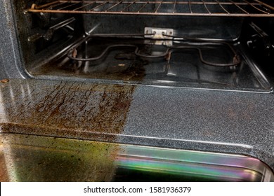 View Inside Electric Oven With One Half Shiny Clean And Half Filthy Dirty Covered In Burnt Grease And Food On Glass Door. Housecleaning Concept And Comparison