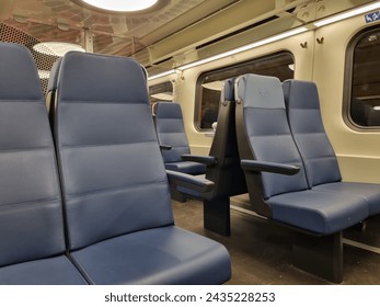 View inside an empty Dutch train driving in the Netherlands in the evening. 