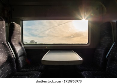 View From Inside A English High Speed Train, Travel To Destination With Noone On Board. Trains Empty During Uk Pandemic Lockdown. View Of The Harsh Morning Sun Outside The Window