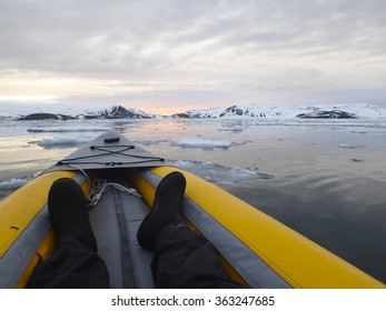 View Inside Kayak Of Sun Setting Over Ice Field In Antarctica.