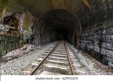 A view inside a long abandoned Baltimore and Ohio Railroad tunnel west of Washington, Pennsylvania. The tracks, ballast and ties are in excellent condition, as is the stone, brick and concrete arch.