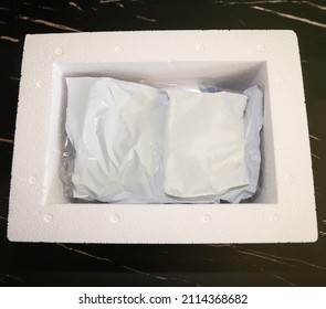 View Of The Inside Of Package Received By Mail With Medication That Needs Refrigeration Packed With Gel Refrigerant In A Styrofoam Cooler.