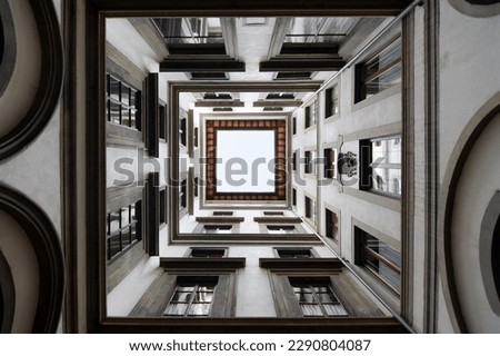 A view inside a square patio inside a block in Florence Italy, looking up